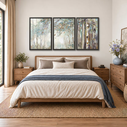 Slender woodland trunks and delicate branches in soft green and cream 3 piece framed canvas wall art styled in an interior