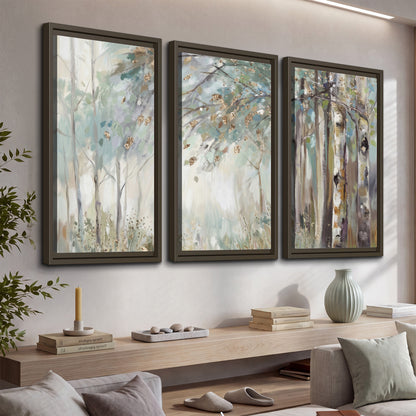 Slender woodland trunks and delicate branches in soft green and cream 3 piece framed canvas wall art displayed in a console