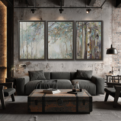 Slender woodland trunks and delicate branches in soft green and cream 3 piece framed canvas wall art displayed in a industrial room