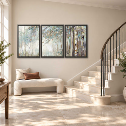 Slender woodland trunks and delicate branches in soft green and cream 3 piece framed canvas wall art styled in an interior