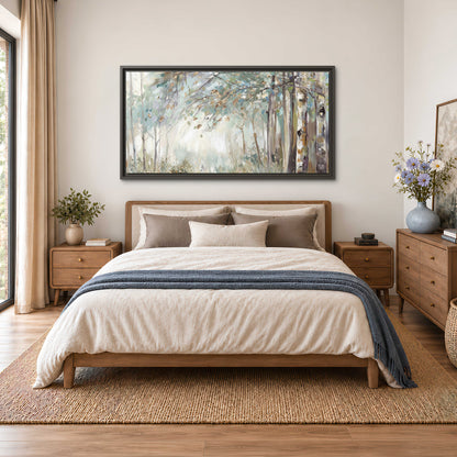 Slender woodland trunks and delicate branches in soft green and cream single framed canvas wall art styled in an interior