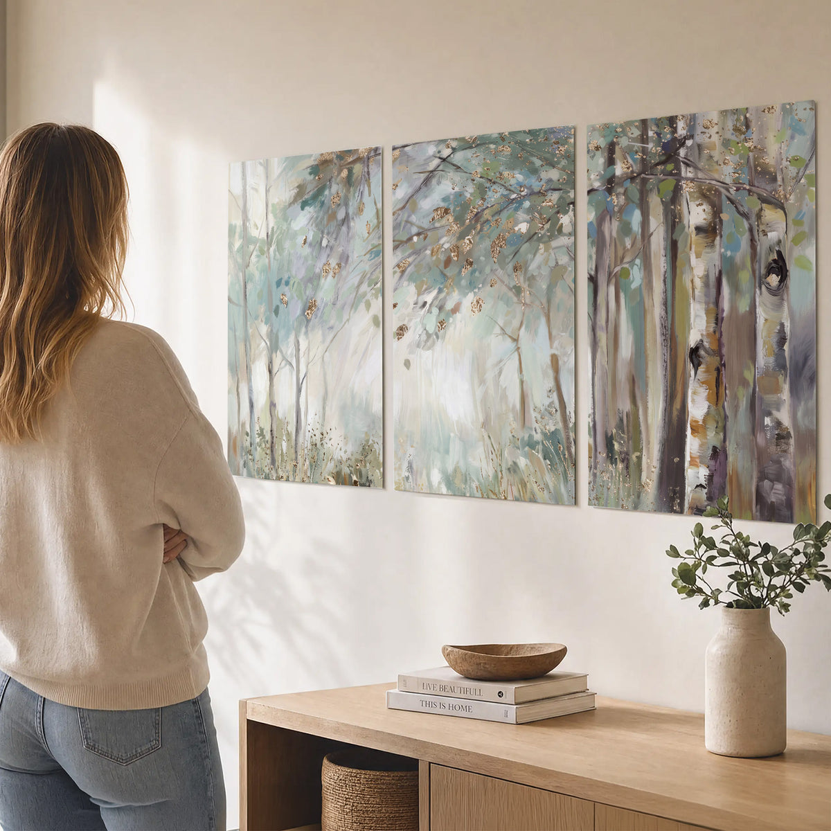 Slender woodland trunks and delicate branches in soft green and cream set of 3 poster prints three panel arrangement on a wall