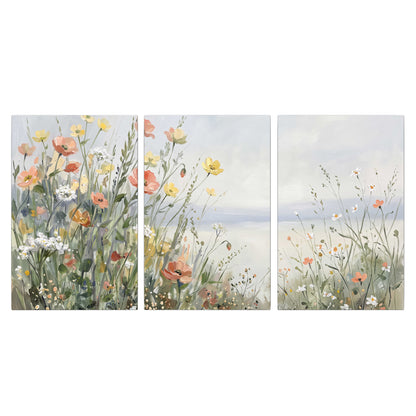 Small colorful wildflowers and light grasses beside a pale lake 3 piece canvas wall art viewed straight on