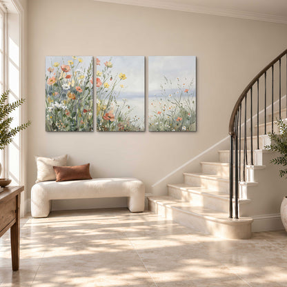 Small colorful wildflowers and light grasses beside a pale lake 3 piece canvas wall art styled in an interior