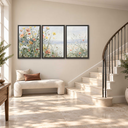 Small colorful wildflowers and light grasses beside a pale lake 3 piece framed canvas wall art styled in an interior