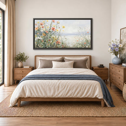 Small colorful wildflowers and light grasses beside a pale lake single framed canvas wall art styled in an interior