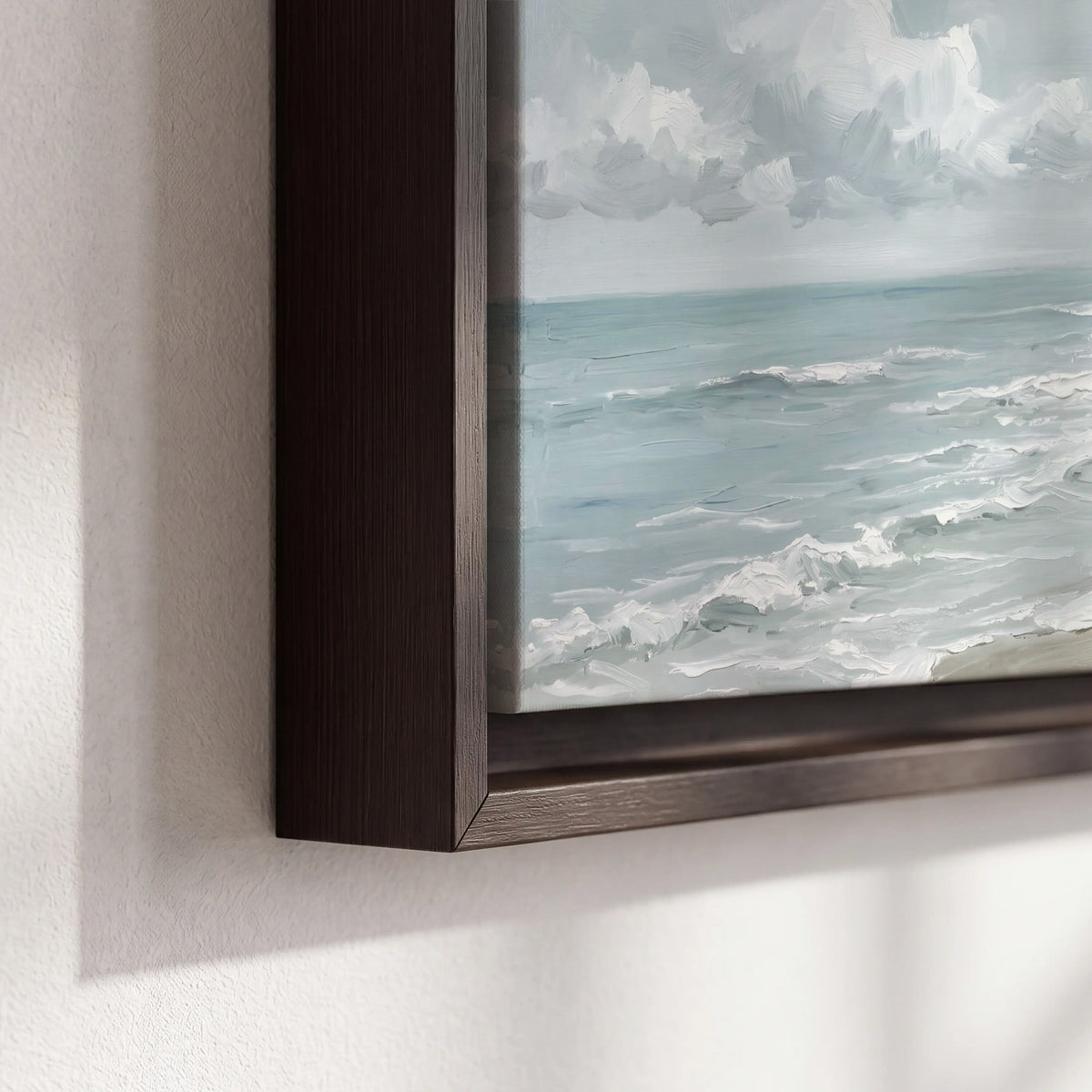 Gentle pale blue waves washing across a light sandy beach 3 piece framed canvas wall art material and edge close up