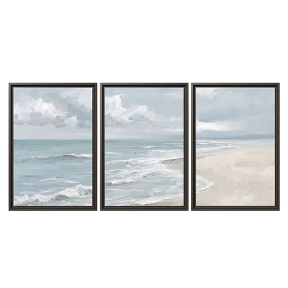 Gentle pale blue waves washing across a light sandy beach 3 piece framed canvas wall art viewed straight on