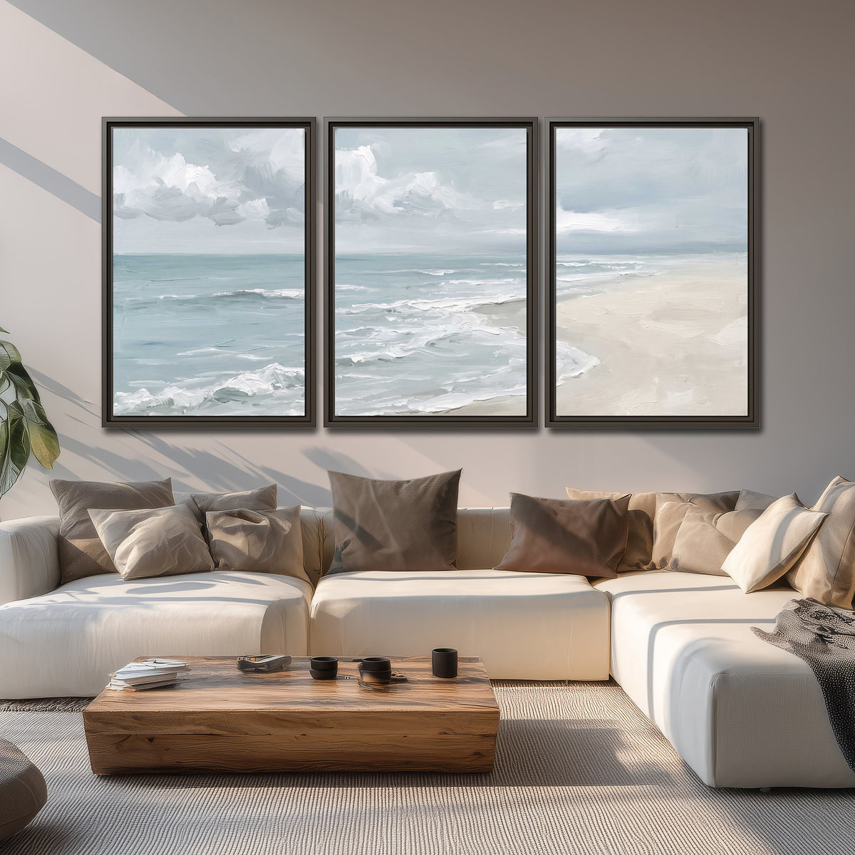 Gentle pale blue waves washing across a light sandy beach 3 piece framed canvas wall art displayed in a living room