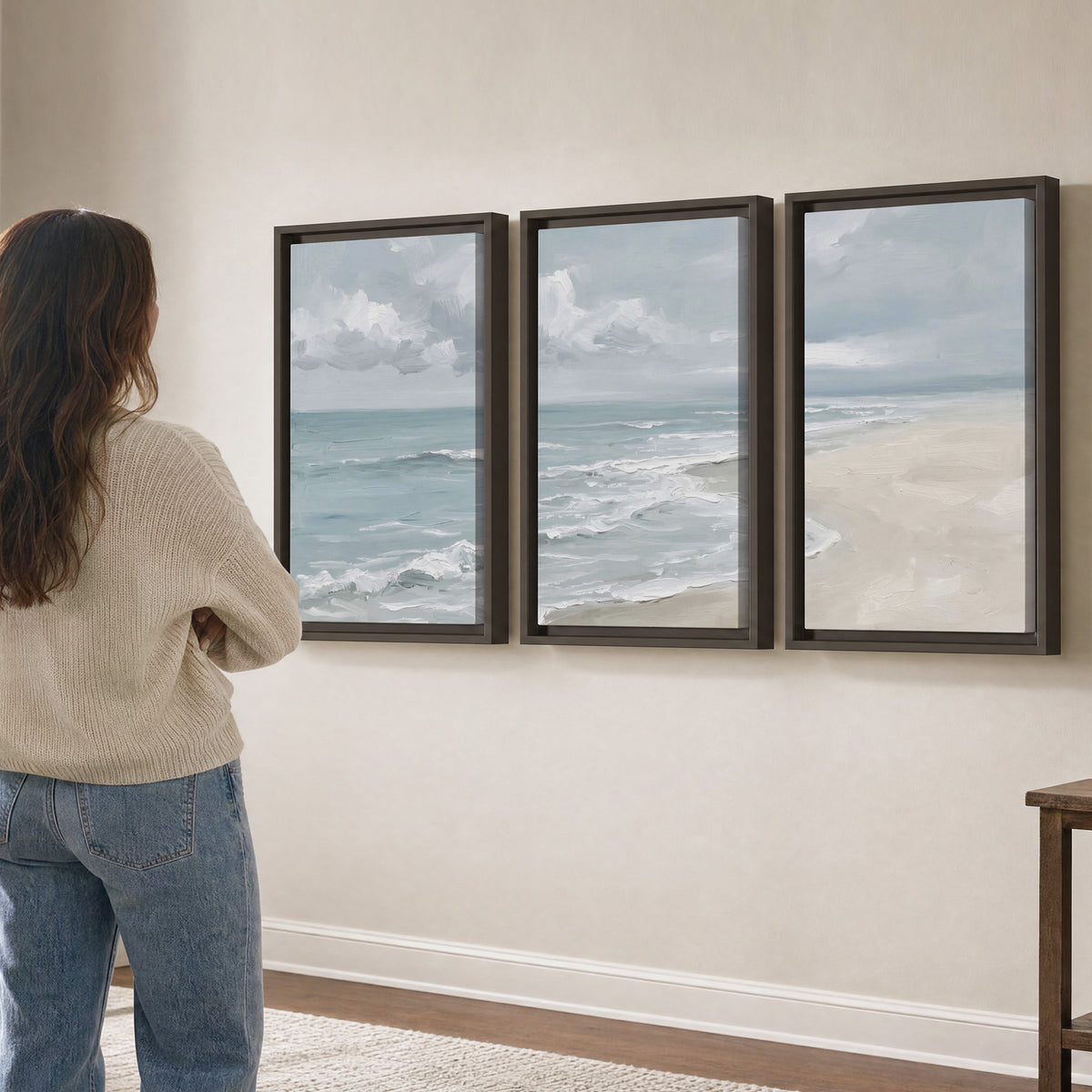 Gentle pale blue waves washing across a light sandy beach 3 piece framed canvas wall art three panel arrangement on a wall