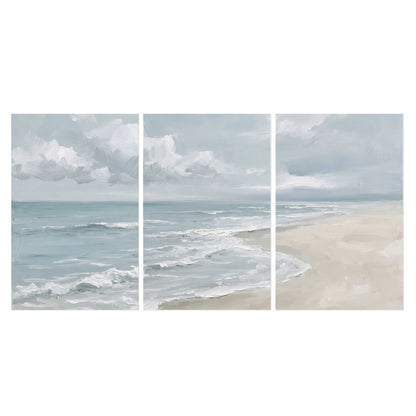 Gentle pale blue waves washing across a light sandy beach set of 3 poster prints viewed straight on