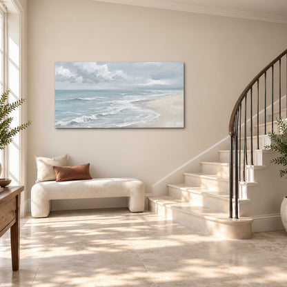 Gentle pale blue waves washing across a light sandy beach single canvas wall art styled in an interior