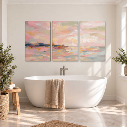 Pink, peach and yellow painted-style sky and water reflections 3 piece canvas wall art styled in an interior