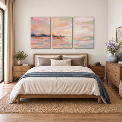 Pink, peach and yellow painted-style sky and water reflections 3 piece canvas wall art styled in an interior