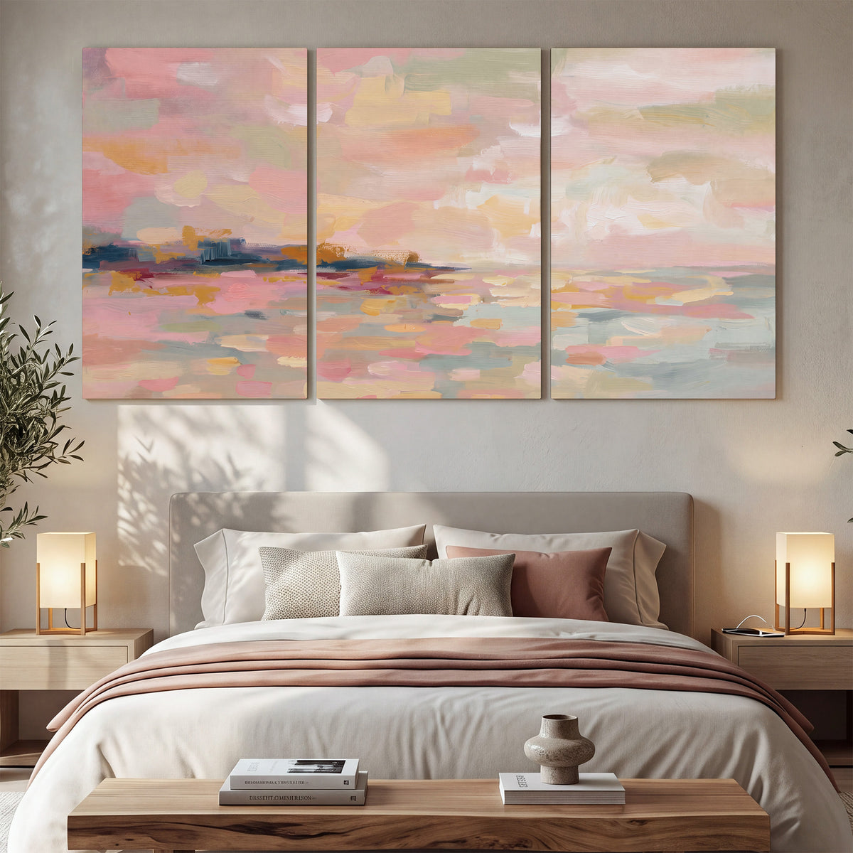 Pink, peach and yellow painted-style sky and water reflections 3 piece canvas wall art displayed in a bedroom