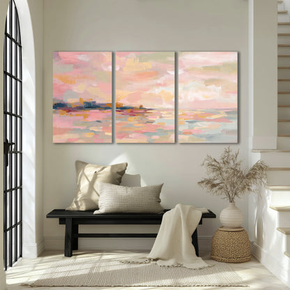 Pink, peach and yellow painted-style sky and water reflections 3 piece canvas wall art displayed in a entryway