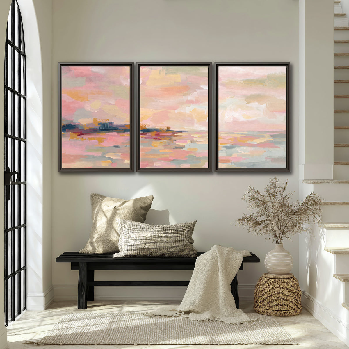 Pink, peach and yellow painted-style sky and water reflections 3 piece framed canvas wall art displayed in a entryway