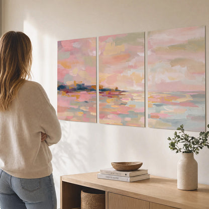 Pink, peach and yellow painted-style sky and water reflections set of 3 poster prints three panel arrangement on a wall
