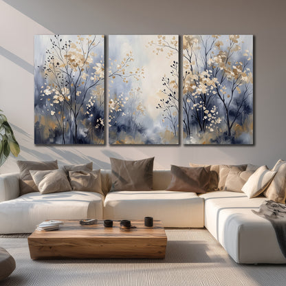Delicate pale gold-colored branches against a deep blue misty background 3 piece canvas wall art displayed in a living room