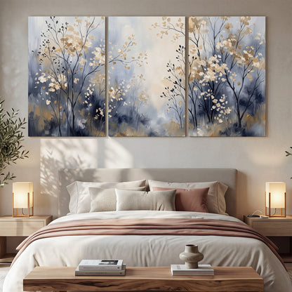 Delicate pale gold-colored branches against a deep blue misty background 3 piece canvas wall art displayed in a bedroom