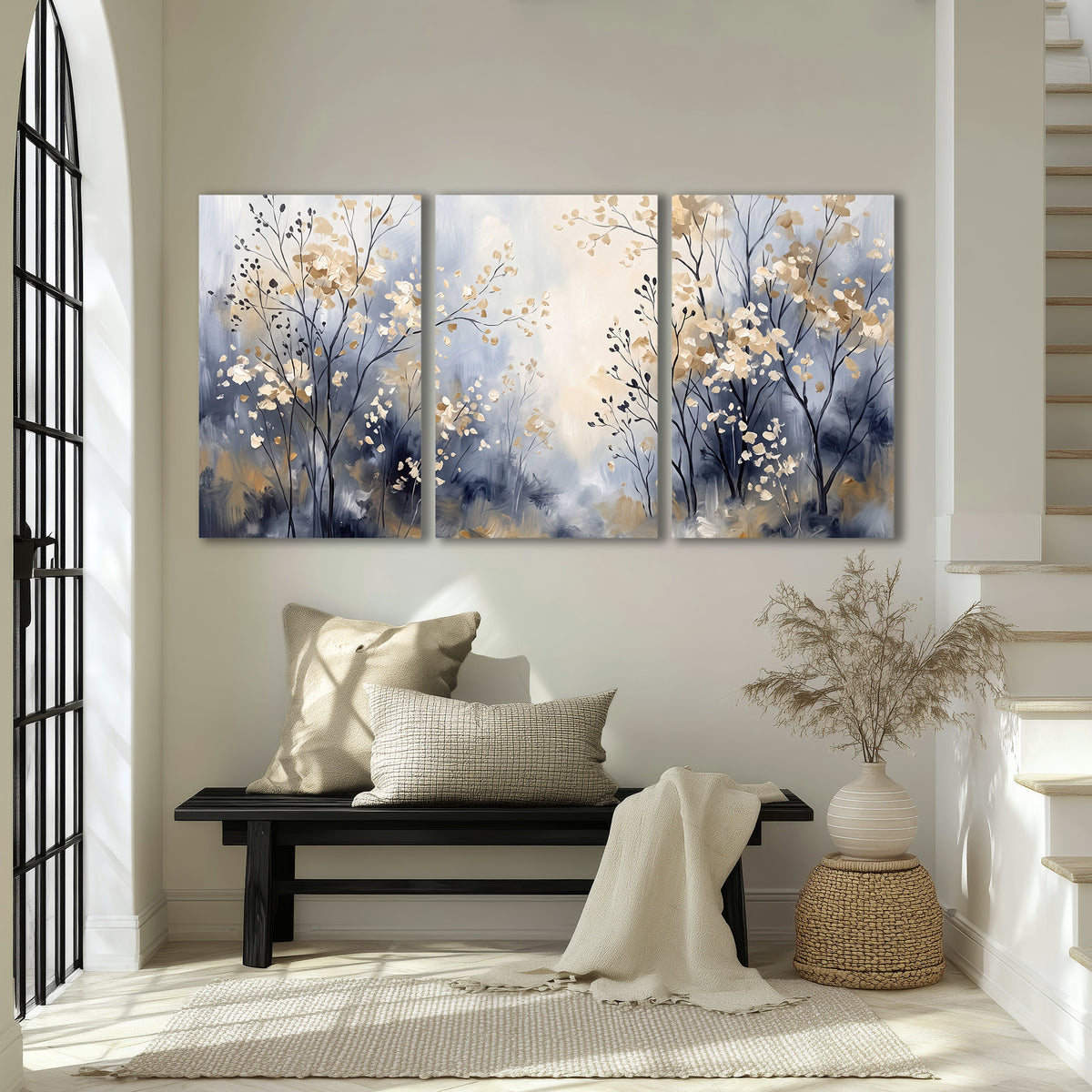 Delicate pale gold-colored branches against a deep blue misty background 3 piece canvas wall art displayed in a entryway