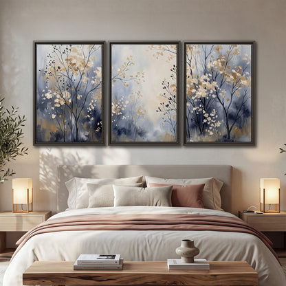 Delicate pale gold-colored branches against a deep blue misty background 3 piece framed canvas wall art displayed in a bedroom
