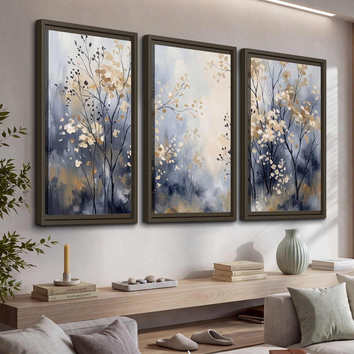 Delicate pale gold-colored branches against a deep blue misty background 3 piece framed canvas wall art displayed in a console