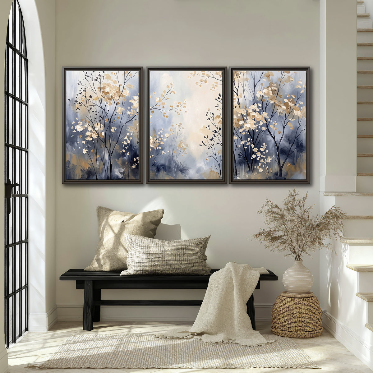 Delicate pale gold-colored branches against a deep blue misty background 3 piece framed canvas wall art displayed in a entryway
