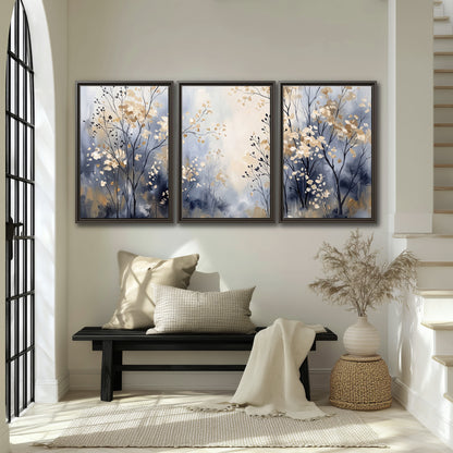 Delicate pale gold-colored branches against a deep blue misty background 3 piece framed canvas wall art displayed in a entryway