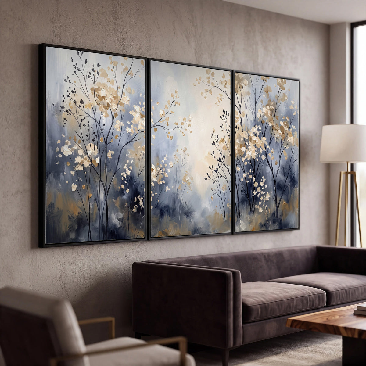 Delicate pale gold-colored branches against a deep blue misty background 3 piece framed canvas wall art displayed in a modern living room