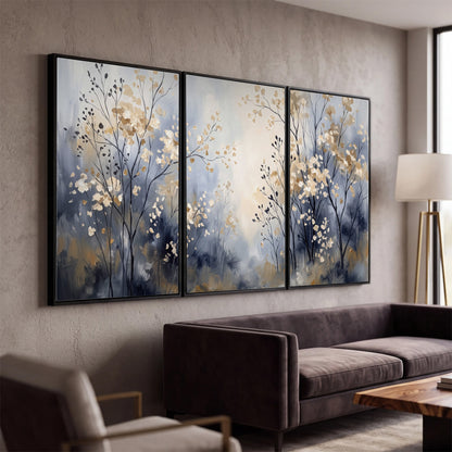 Delicate pale gold-colored branches against a deep blue misty background 3 piece framed canvas wall art displayed in a modern living room