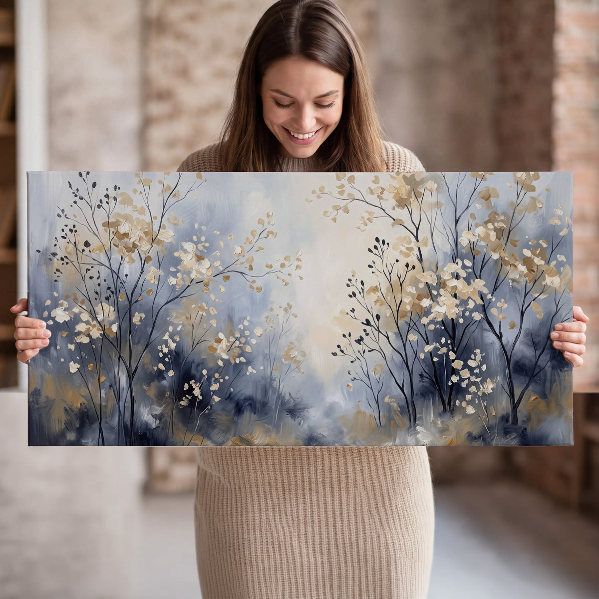 Delicate pale gold-colored branches against a deep blue misty background single canvas wall art held in hands