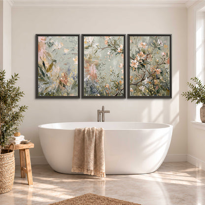 Delicate pink and ivory flowering branches against muted sage green 3 piece framed canvas wall art styled in an interior