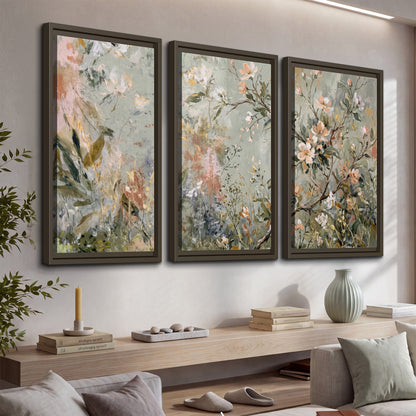 Delicate pink and ivory flowering branches against muted sage green 3 piece framed canvas wall art displayed in a console