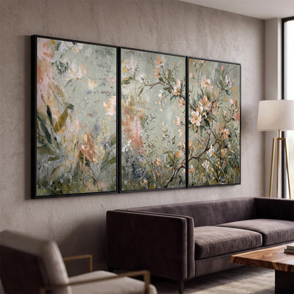 Delicate pink and ivory flowering branches against muted sage green 3 piece framed canvas wall art displayed in a modern living room