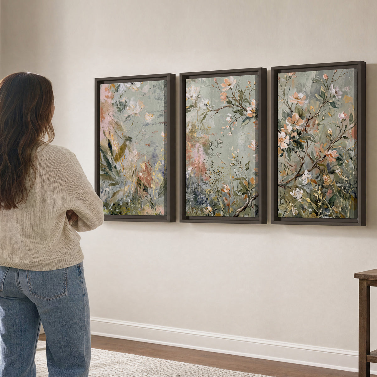 Delicate pink and ivory flowering branches against muted sage green 3 piece framed canvas wall art three panel arrangement on a wall