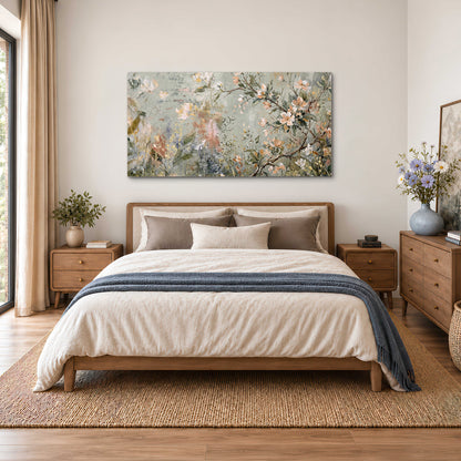 Delicate pink and ivory flowering branches against muted sage green single canvas wall art styled in an interior