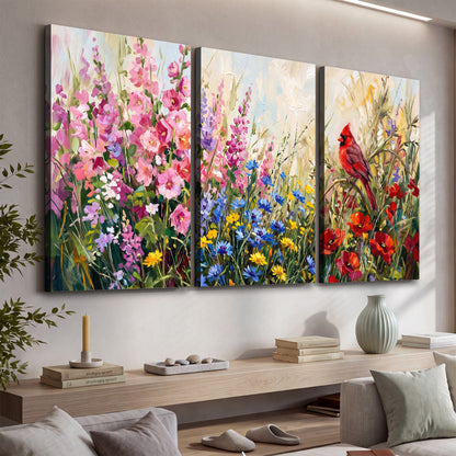 A bright red cardinal among vivid pink, blue and yellow wildflowers 3 piece canvas wall art displayed in a console