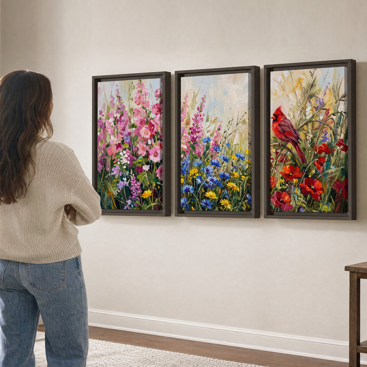 A bright red cardinal among vivid pink, blue and yellow wildflowers 3 piece framed canvas wall art three panel arrangement on a wall