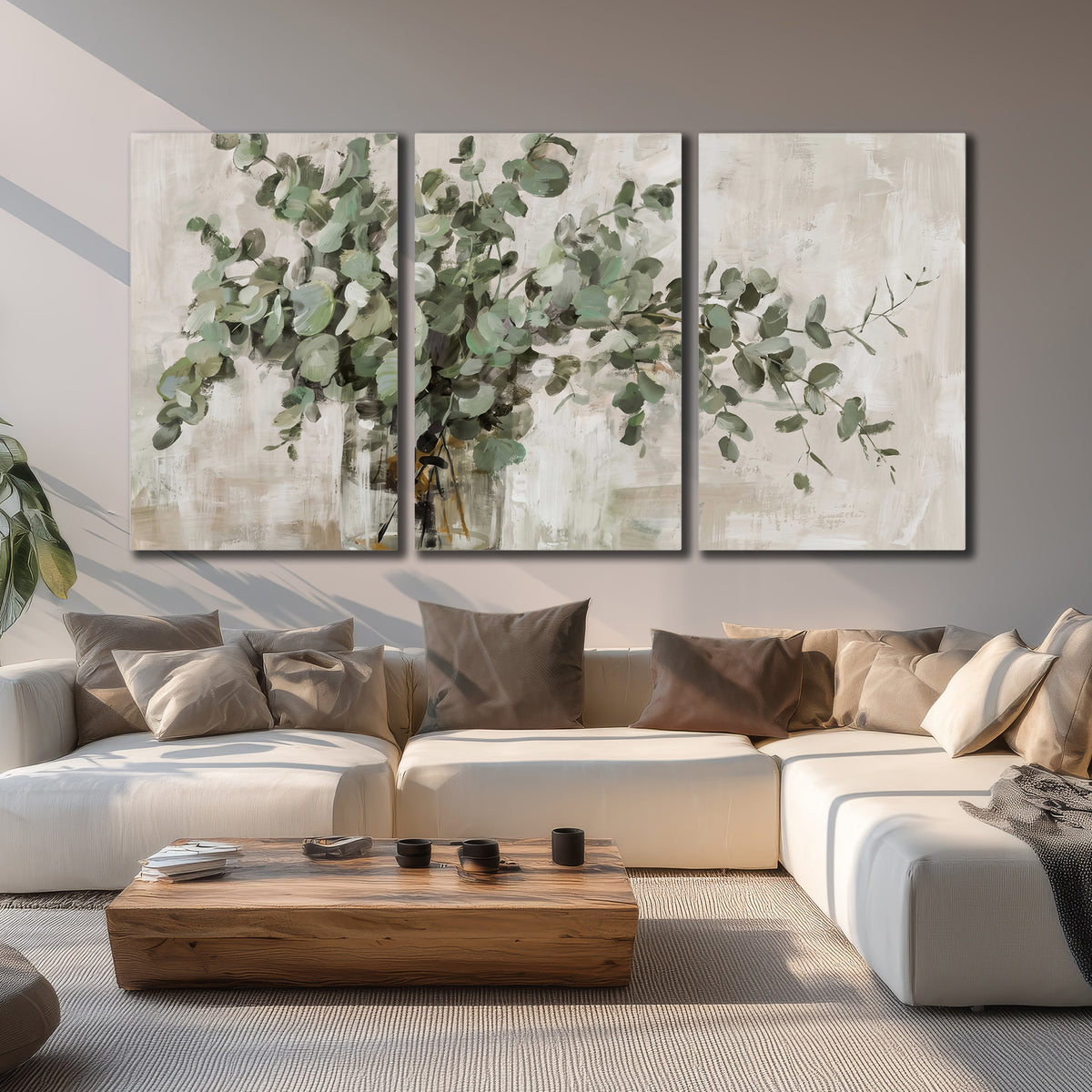 Soft sage eucalyptus leaves and pale stems on a warm cream background 3 piece canvas wall art displayed in a living room