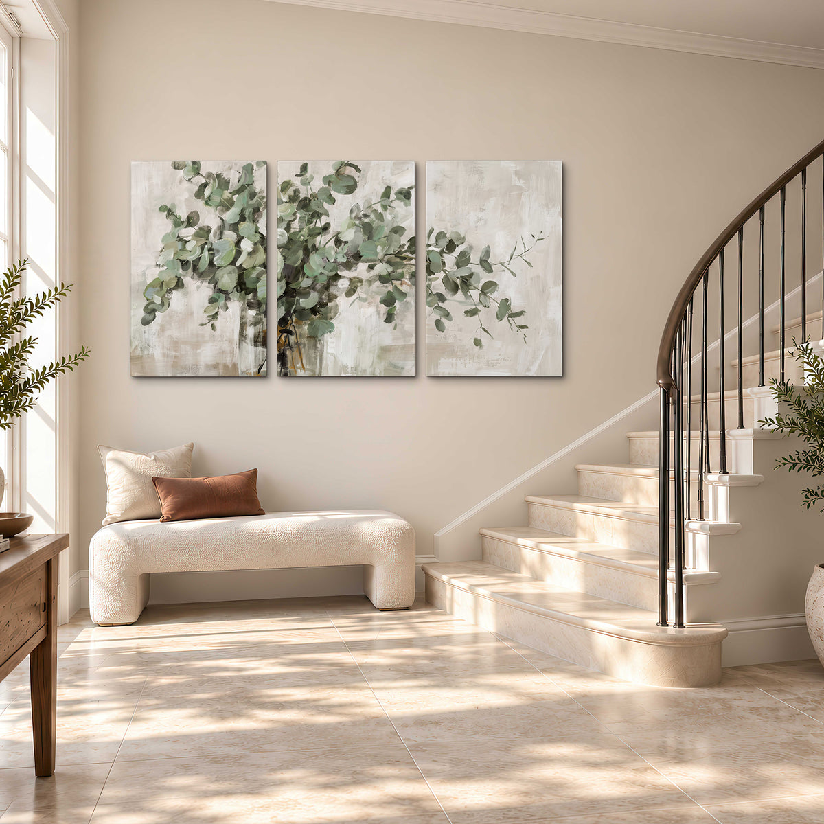 Soft sage eucalyptus leaves and pale stems on a warm cream background 3 piece canvas wall art styled in an interior