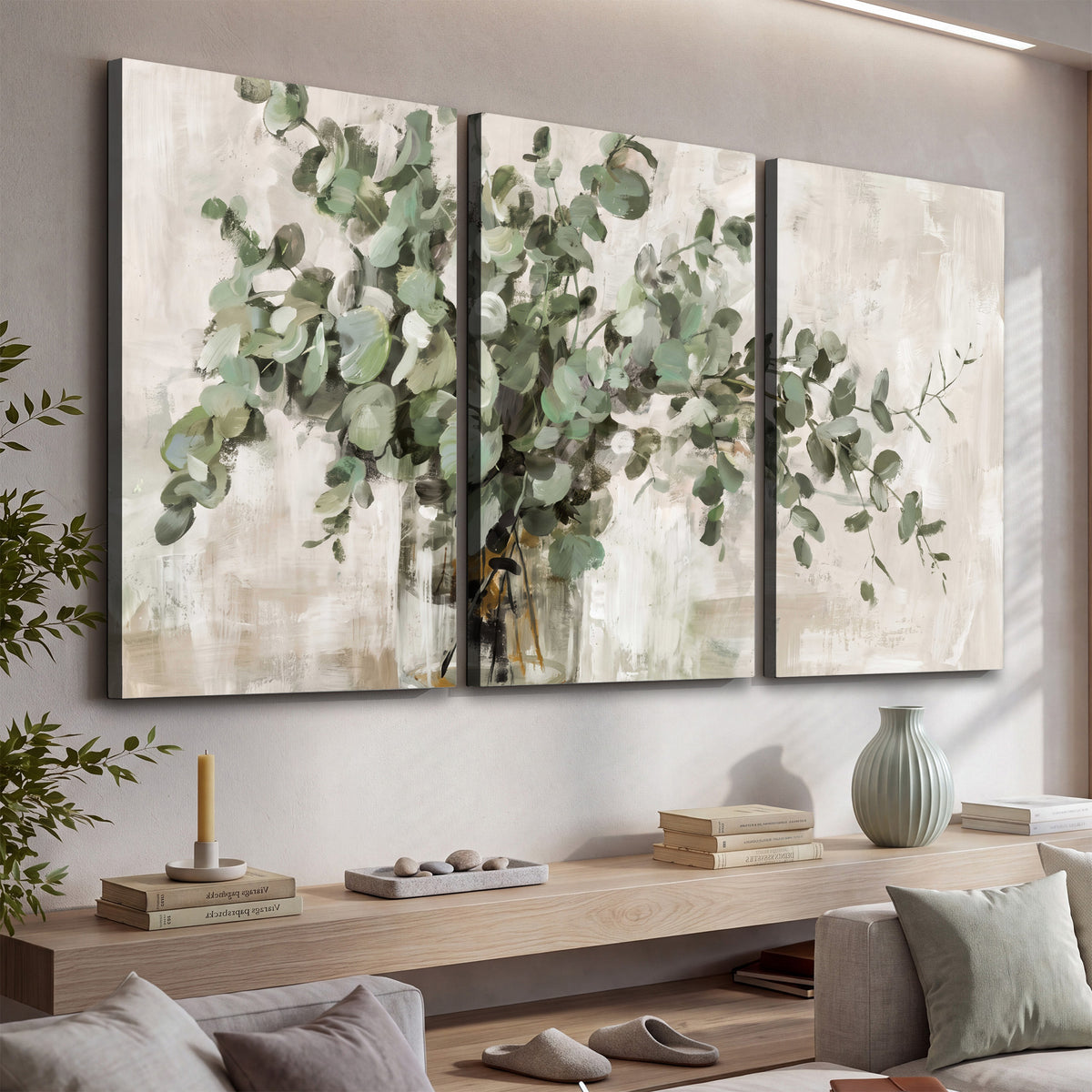 Soft sage eucalyptus leaves and pale stems on a warm cream background 3 piece canvas wall art displayed in a console