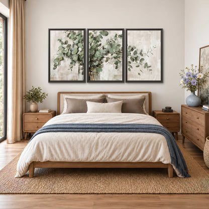 Soft sage eucalyptus leaves and pale stems on a warm cream background 3 piece framed canvas wall art styled in an interior