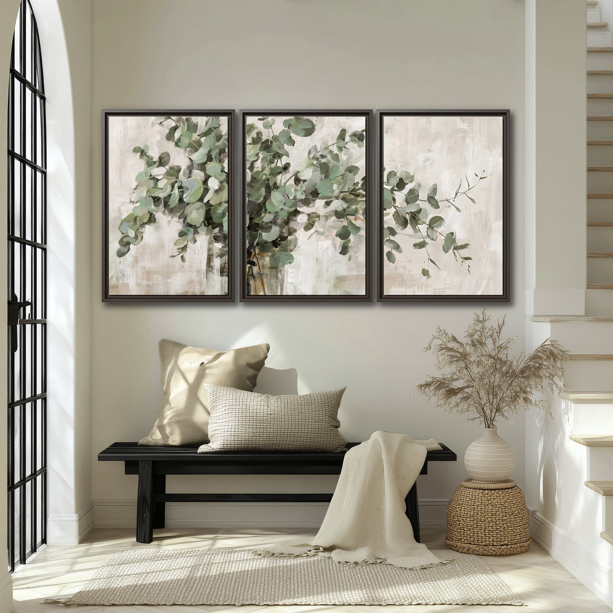 Soft sage eucalyptus leaves and pale stems on a warm cream background 3 piece framed canvas wall art displayed in a entryway
