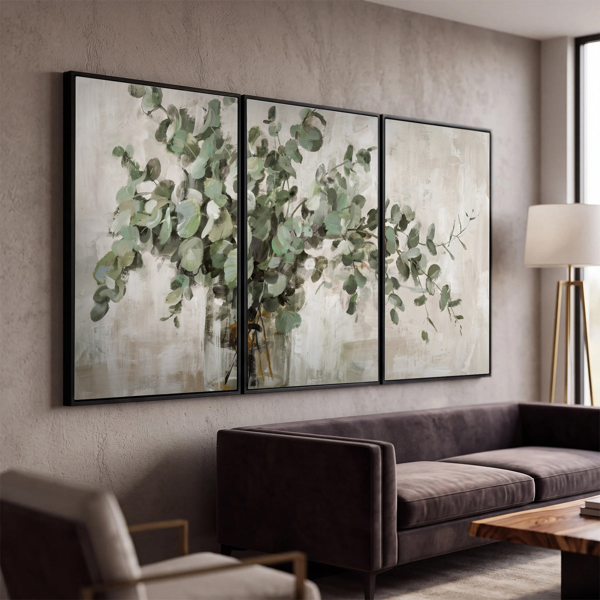 Soft sage eucalyptus leaves and pale stems on a warm cream background 3 piece framed canvas wall art displayed in a modern living room