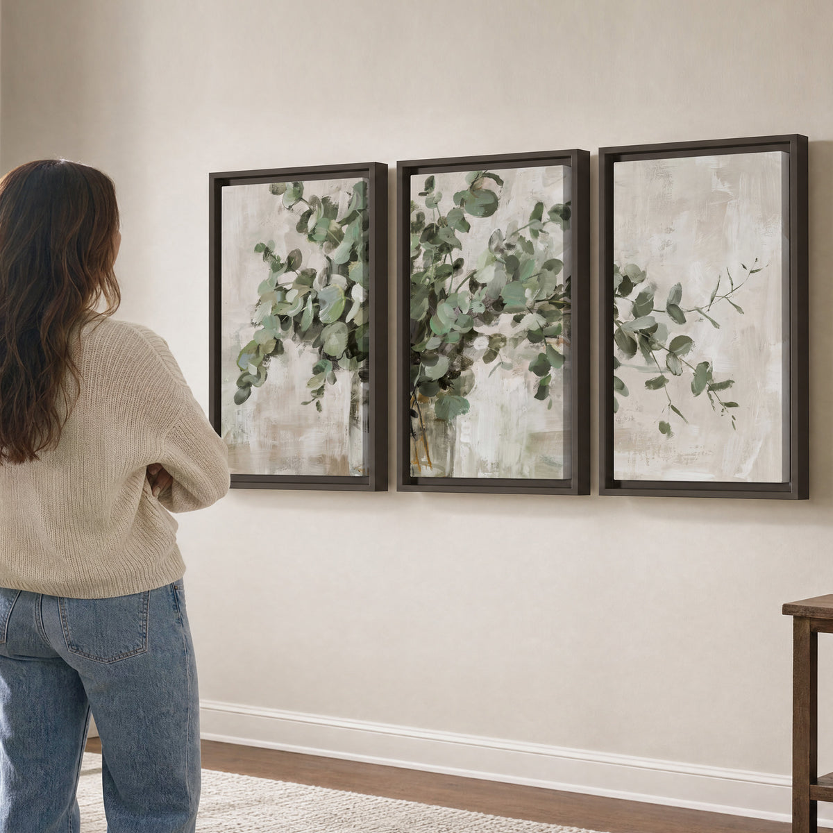 Soft sage eucalyptus leaves and pale stems on a warm cream background 3 piece framed canvas wall art three panel arrangement on a wall