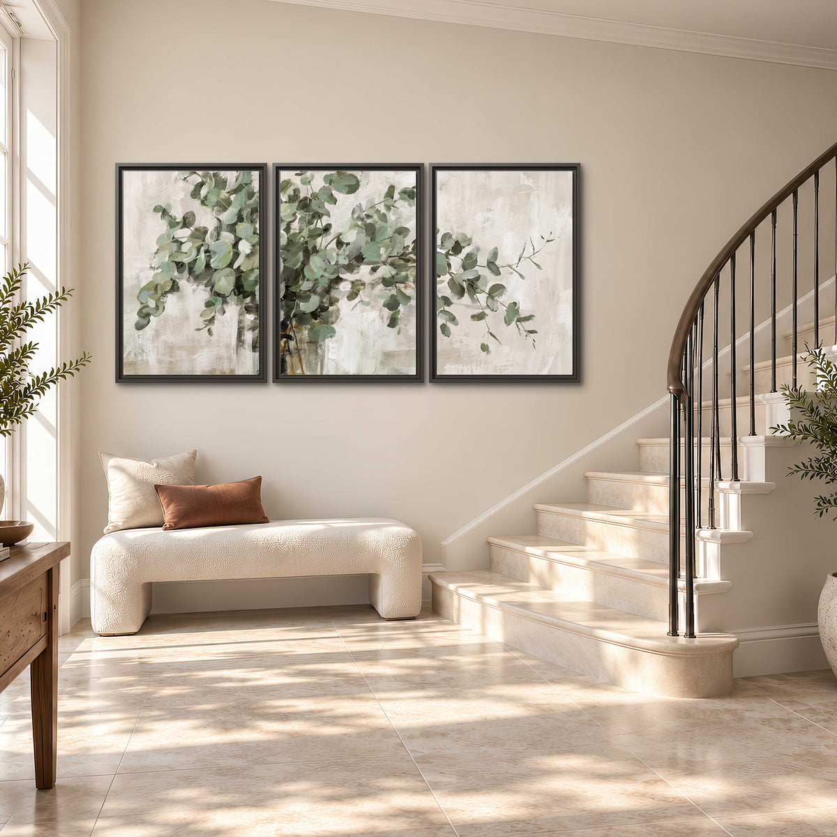 Soft sage eucalyptus leaves and pale stems on a warm cream background 3 piece framed canvas wall art styled in an interior