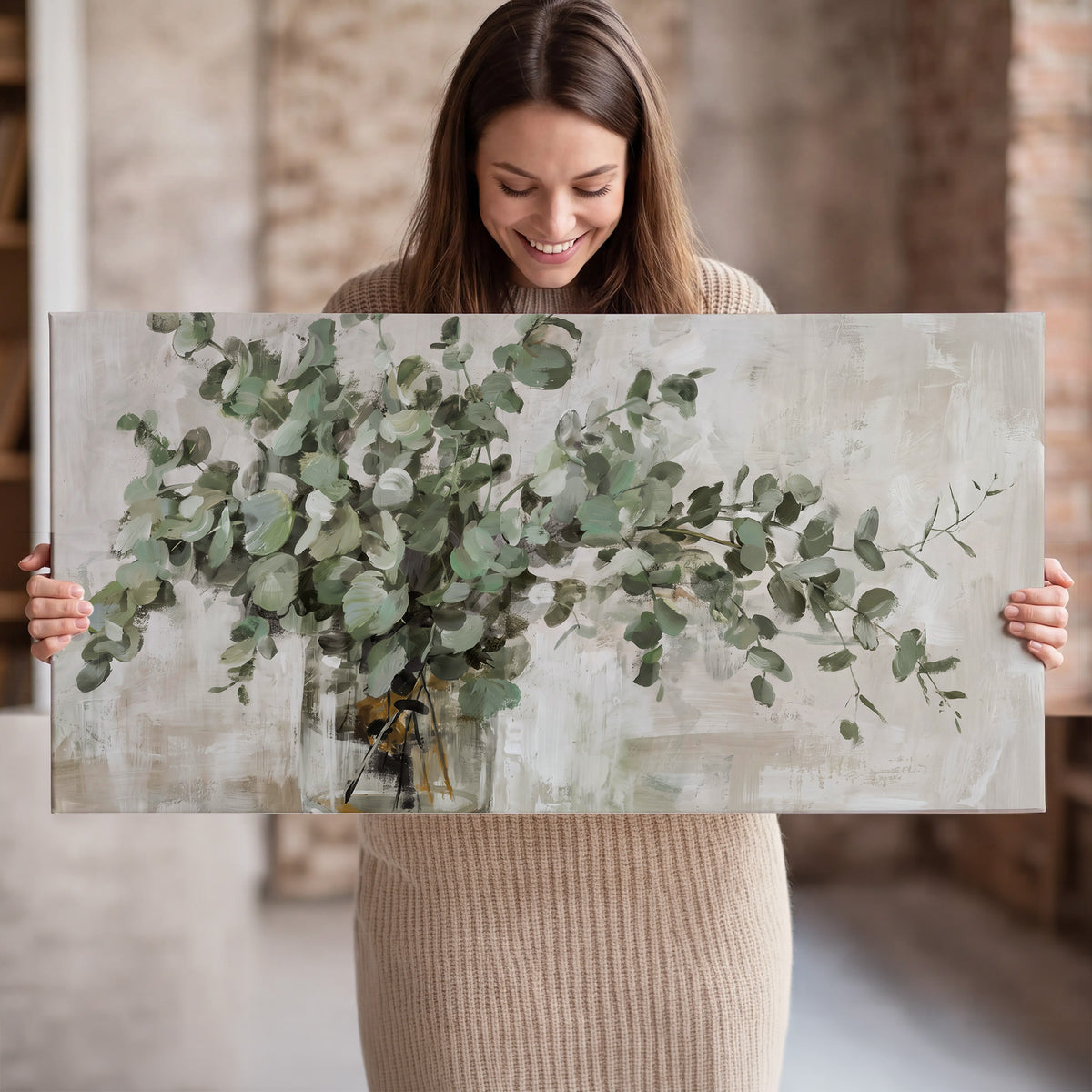 Soft sage eucalyptus leaves and pale stems on a warm cream background single canvas wall art held in hands