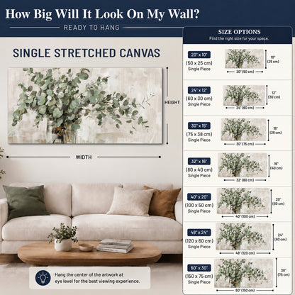 Soft sage eucalyptus leaves and pale stems on a warm cream background single canvas wall art size guide above a sofa; room view is illustrative