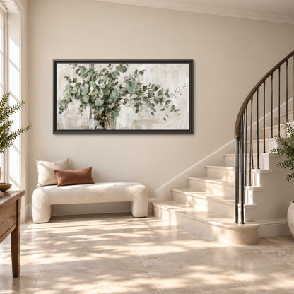 Soft sage eucalyptus leaves and pale stems on a warm cream background single framed canvas wall art styled in an interior